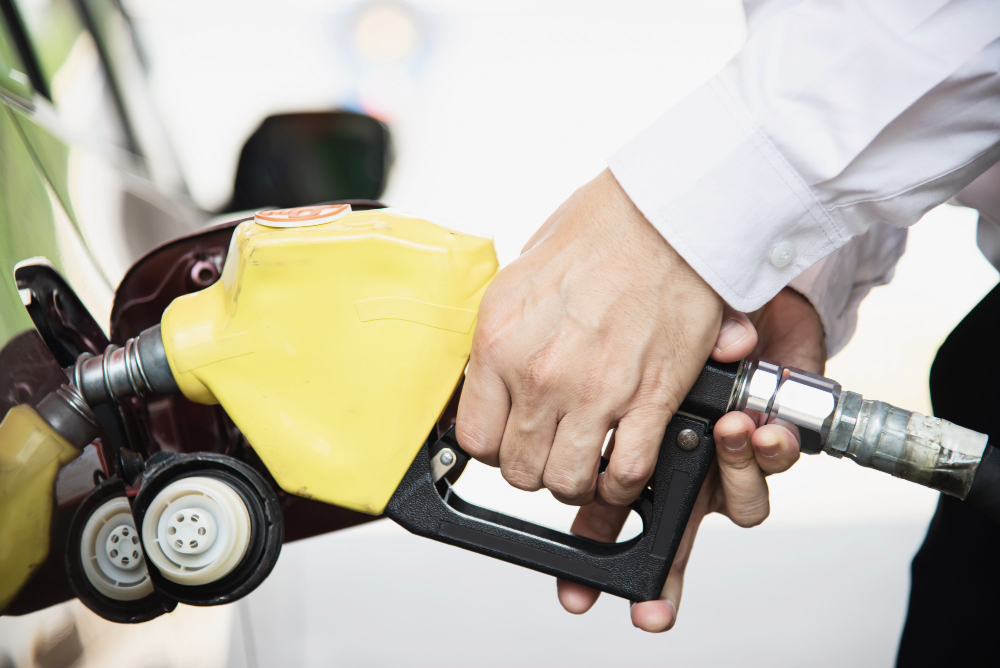 Persona abasteciendo gasolina Extra y Ecopaís en Ecuador tras nueva reducción de precios en noviembre de 2025.